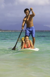 couple on standup paddle board in hawaii