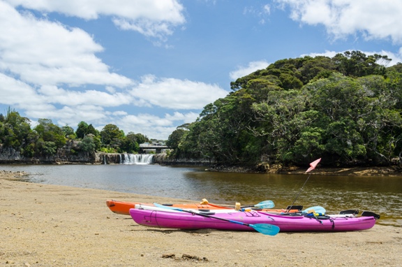 Two kayaks in front of Haruru Falls, New Zealand