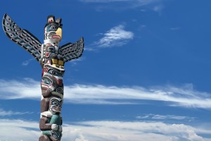 isolated totem wood pole in the blue cloudy background